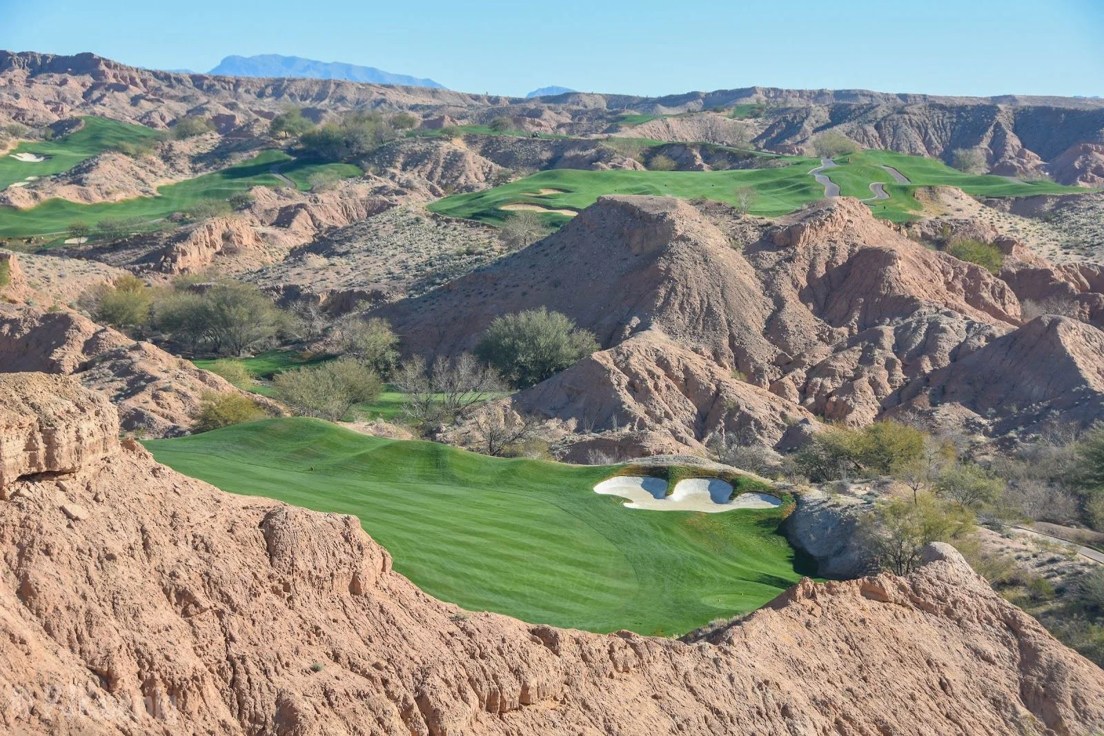 Wolf Creek Golf Club Mesquite — dramatic canyon hole framed by red rock formations